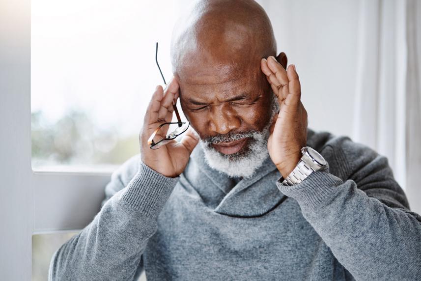 Older man experiencing a migraine attack 